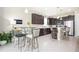 Modern kitchen with dark cabinetry, stainless steel appliances, and an island at 11721 Brighton Knoll Loop, Riverview, FL 33579