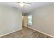 Simple bedroom with wood-look floors and neutral walls at 907 136Th E St, Bradenton, FL 34212