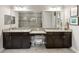 Double vanity bathroom with granite countertop and large mirror at 4803 Cabreo Ct, Bradenton, FL 34211