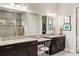 Bathroom with granite countertop double vanity and large mirror at 4803 Cabreo Ct, Bradenton, FL 34211