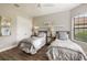 Bedroom with two twin beds, ceiling fan, and large window at 4803 Cabreo Ct, Bradenton, FL 34211