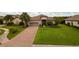 Luxury home with a large lawn and brick driveway at 4803 Cabreo Ct, Bradenton, FL 34211