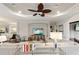 Spacious living room featuring a large sectional sofa, hardwood floors, and a modern entertainment center at 4803 Cabreo Ct, Bradenton, FL 34211