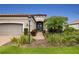 One-story home with gray garage door and manicured lawn at 4803 Cabreo Ct, Bradenton, FL 34211