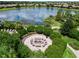 Community fire pit with seating and landscaping, overlooking a lake at 4803 Cabreo Ct, Bradenton, FL 34211