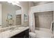 Bathroom with tub, shower, granite vanity, and neutral decor at 4803 Cabreo Ct, Bradenton, FL 34211