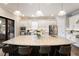 Gourmet kitchen boasts a large island with seating, stainless steel appliances, and white cabinetry at 4803 Cabreo Ct, Bradenton, FL 34211
