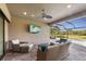 Relaxing outdoor patio with seating area, TV, and view of the pool at 4803 Cabreo Ct, Bradenton, FL 34211