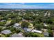Aerial view of neighborhood with houses, trees, and ocean in the background at 2907 Marshall Dr, Sarasota, FL 34239