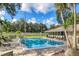 Community pool with surrounding lounge chairs at 3541 Wilkinson Woods Dr # 40, Sarasota, FL 34231