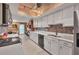 Galley kitchen with white cabinets, stainless appliances, tile backsplash and stone countertops at 3541 Wilkinson Woods Dr # 40, Sarasota, FL 34231