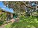 Backyard with patio, lush landscaping, and large oak trees at 3541 Wilkinson Woods Dr # 40, Sarasota, FL 34231