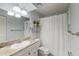 Bathroom featuring granite vanity and shower with curtain at 3601 Quail Hollow Ln, Bradenton, FL 34210