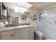 Bright bathroom featuring a walk-in shower, granite countertops, and ample storage at 3601 Quail Hollow Ln, Bradenton, FL 34210