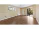 An empty bedroom features wood floors, closet space and access to a screened lanai at 3601 Quail Hollow Ln, Bradenton, FL 34210