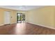 An empty bedroom features wood floors, closet space and access to a screened lanai at 3601 Quail Hollow Ln, Bradenton, FL 34210