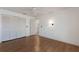 Bright bedroom featuring wood floors, ceiling fan, and closet at 3601 Quail Hollow Ln, Bradenton, FL 34210