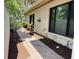 Inviting pathway lined with lush landscaping, leading to the home's entrance with window views at 3601 Quail Hollow Ln, Bradenton, FL 34210