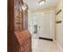 Inviting foyer with tile flooring, a vintage hutch, and a bright entryway at 3601 Quail Hollow Ln, Bradenton, FL 34210