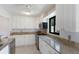 Stylish kitchen boasts white cabinets, granite countertops and stainless steel appliances at 3601 Quail Hollow Ln, Bradenton, FL 34210