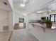 An open kitchen with white cabinets, granite countertops, and a stainless steel microwave at 3601 Quail Hollow Ln, Bradenton, FL 34210