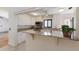 Well-lit kitchen with white cabinets, granite countertops, breakfast bar and stainless steel appliances at 3601 Quail Hollow Ln, Bradenton, FL 34210