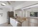 An open-concept kitchen featuring white cabinets, stainless steel appliances and granite countertops at 3601 Quail Hollow Ln, Bradenton, FL 34210