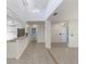 Spacious open-concept living area with tile floors and granite breakfast bar at 3601 Quail Hollow Ln, Bradenton, FL 34210