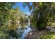 Beautiful pond with a fountain surrounded by lush greenery at 3601 Quail Hollow Ln, Bradenton, FL 34210