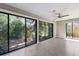 A sunroom surrounded by windows with a view of a lake and garden at 3601 Quail Hollow Ln, Bradenton, FL 34210