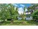 Landscaped front yard with lush green grass and mature trees at 4724 Seville Dr, Sarasota, FL 34235