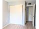 Bedroom with double closet and wood-look flooring at 5933 17Th W St # A24, Bradenton, FL 34207