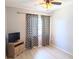 Bedroom with window, curtains, and wood-look flooring at 5933 17Th W St # A24, Bradenton, FL 34207