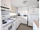 Bright kitchen featuring white cabinets and a full suite of appliances at 5933 17Th W St # A24, Bradenton, FL 34207