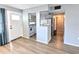 Open living room with wood-look flooring and access to kitchen at 5933 17Th W St # A24, Bradenton, FL 34207