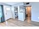 Open living room with wood-look flooring and access to kitchen at 5933 17Th W St # A24, Bradenton, FL 34207