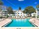 Community pool with surrounding patio furniture at 5933 17Th W St # A24, Bradenton, FL 34207