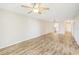 Living room with wood-look flooring and view to kitchen at 3777 Lake Bayshore Dr # H401, Bradenton, FL 34205