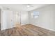 Bright bedroom with wood-look floors and ample closet space at 3777 Lake Bayshore Dr # H401, Bradenton, FL 34205