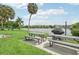 Community lakeside patio with picnic tables and grill at 3777 Lake Bayshore Dr # H401, Bradenton, FL 34205