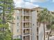 Tan colored apartment building with multiple stories and balconies at 3777 Lake Bayshore Dr # H401, Bradenton, FL 34205