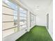 Sunroom with artificial turf flooring and water views at 3777 Lake Bayshore Dr # H401, Bradenton, FL 34205