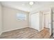 Bright bedroom with wood-look floors and a double closet at 3777 Lake Bayshore Dr # H401, Bradenton, FL 34205