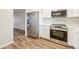 Kitchen with white shaker cabinets, stainless steel appliances and wood flooring at 3777 Lake Bayshore Dr # H401, Bradenton, FL 34205