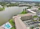 Aerial view of condo community with pool and lake at 3777 Lake Bayshore Dr # H401, Bradenton, FL 34205