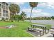 Lakeside patio with picnic table and fire pit at 3777 Lake Bayshore Dr # H401, Bradenton, FL 34205