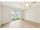 Bright bedroom featuring wood-look floors and sliding glass doors at 3777 Lake Bayshore Dr # H401, Bradenton, FL 34205