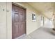 Apartment hallway with brown doors and light colored walls at 3777 Lake Bayshore Dr # H401, Bradenton, FL 34205