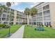 Condo building with manicured lawn and walkway at 3777 Lake Bayshore Dr # H401, Bradenton, FL 34205