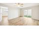 Bright bedroom featuring wood-look floors and sliding glass doors at 3777 Lake Bayshore Dr # H401, Bradenton, FL 34205